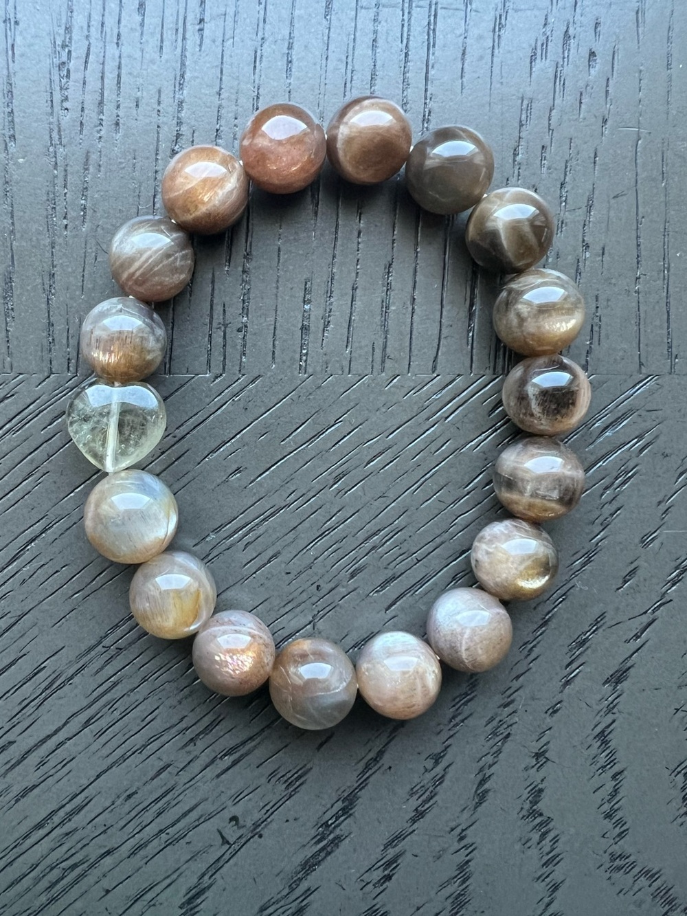 Backbone Sunstone with black feather Auralite heart bracelet 12mm SIZE 7.25’